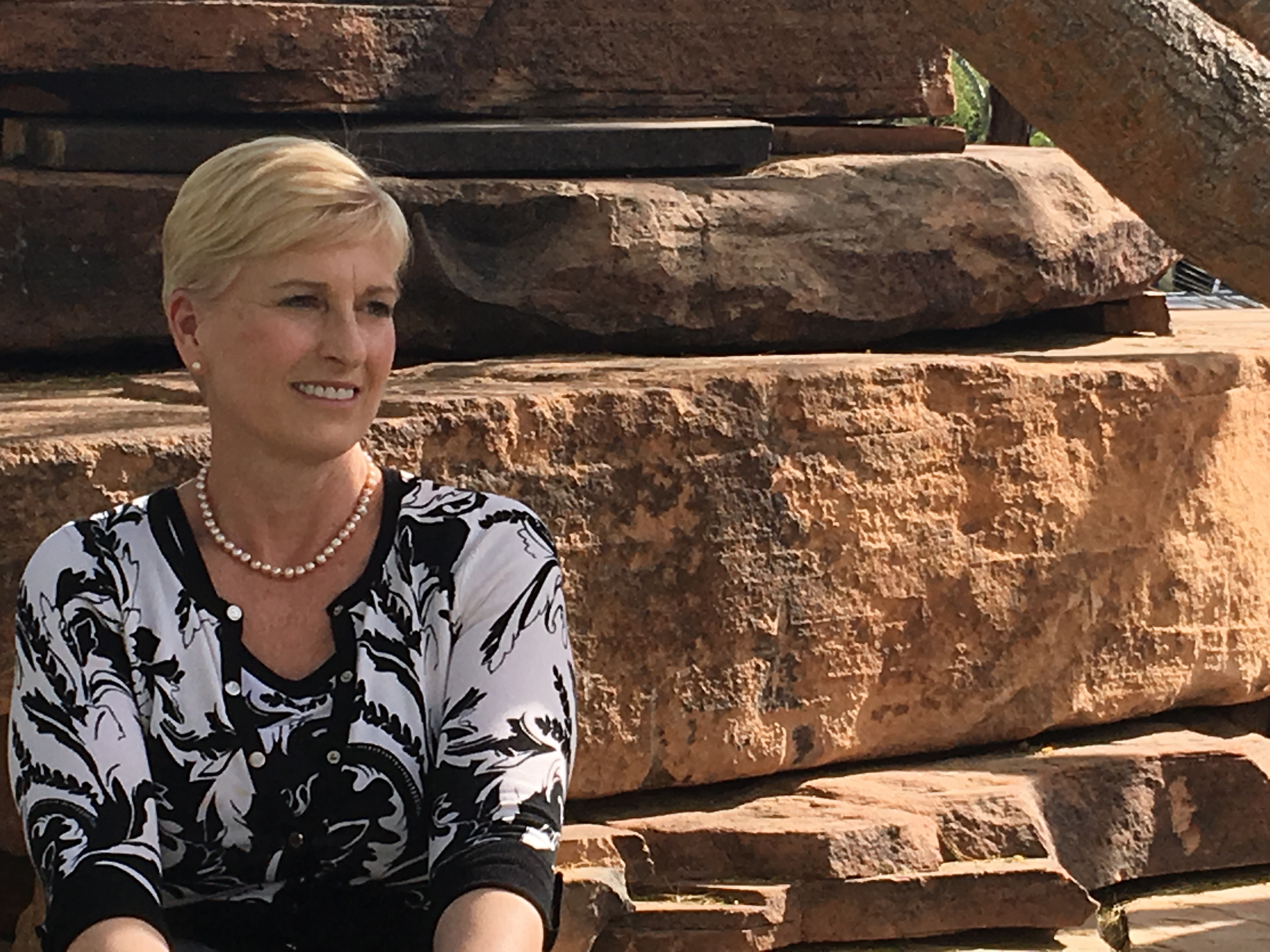 Victims of emotional abuse need support to gain clarity, break free and recover. Dr. Denise Dart sitting on a natural stone bench with an open seat beside her reserved for you. 